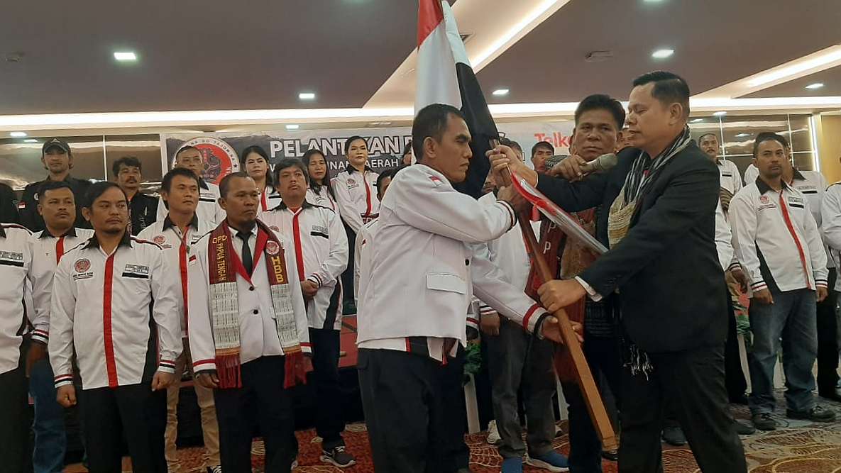 Penyerahan pataka dari Ketua Umum DPP HBB, Lamsihang Sitompul kepada Saul Siburian. Foto: Martha/Papua60detik