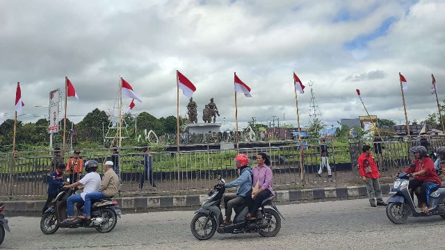 Warga pasang bendera di bundaran Petrosea. Foto; Martha/ Papua60detik