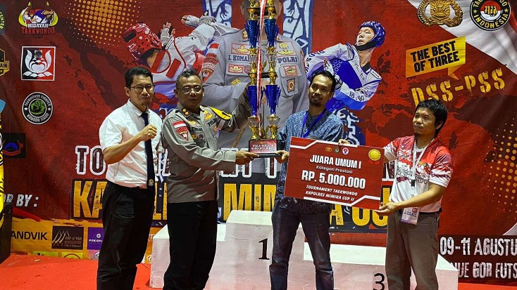 Kapolres Mimika AKBP I Komang Budiartha menyerahkan piala bergilir kepada HTC. Foto: Faris/ Papua60detik