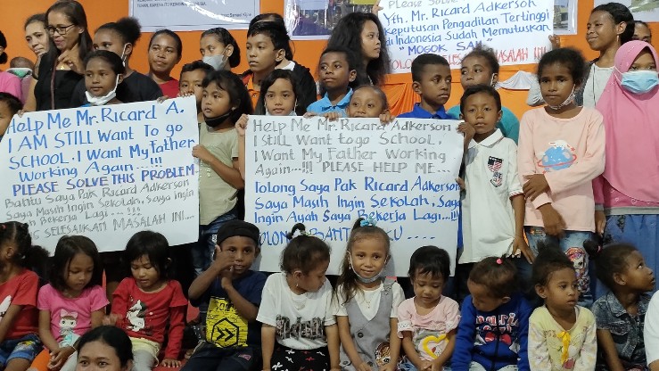 Anak-anak buruh mogok kerja PT Freeport Indonesia dengan poster tuntutan mereka di Gedung Tongkonan, Timika, Minggu (2/1/2022). Foto: Burhan/ Papua60detik