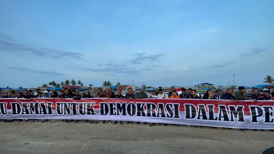 Pembentangan spanduk deklarasi Pemilu damai sepanjang 20 meter oleh komunitas otomotif Merauke. Foto: Ami/Papua60detik